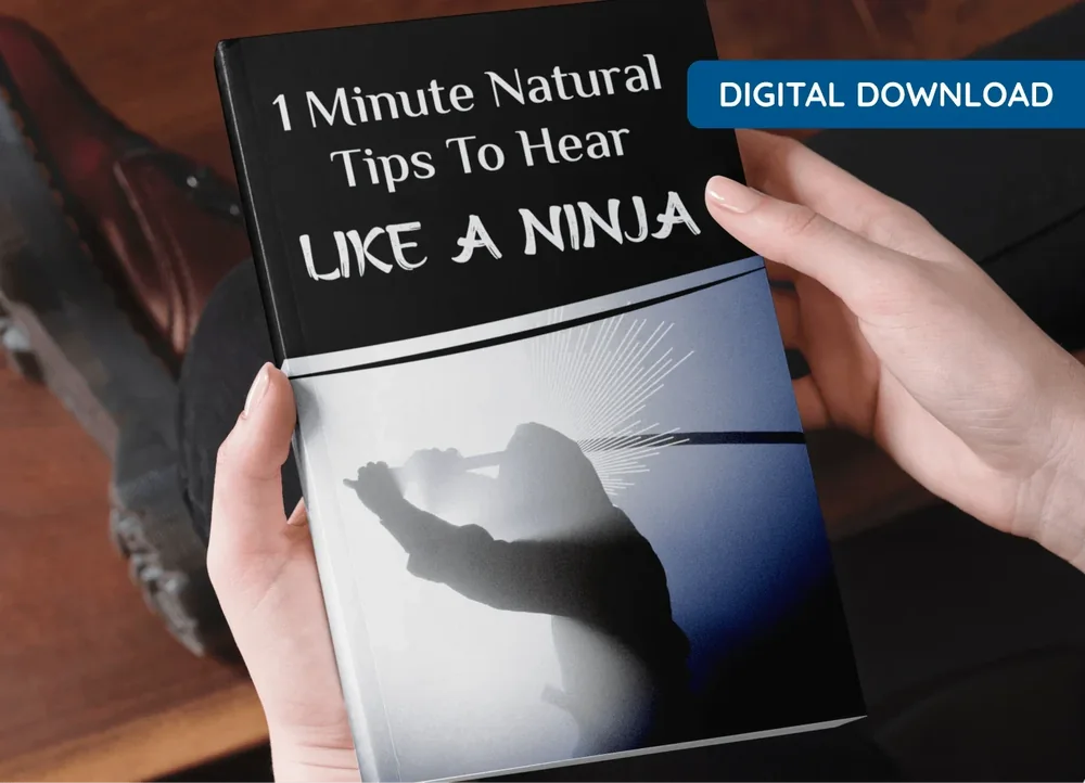 Vendor mock-up of an e-book titled 1 Minute Natural Tips To Hear Like a Ninja, held in two hands
